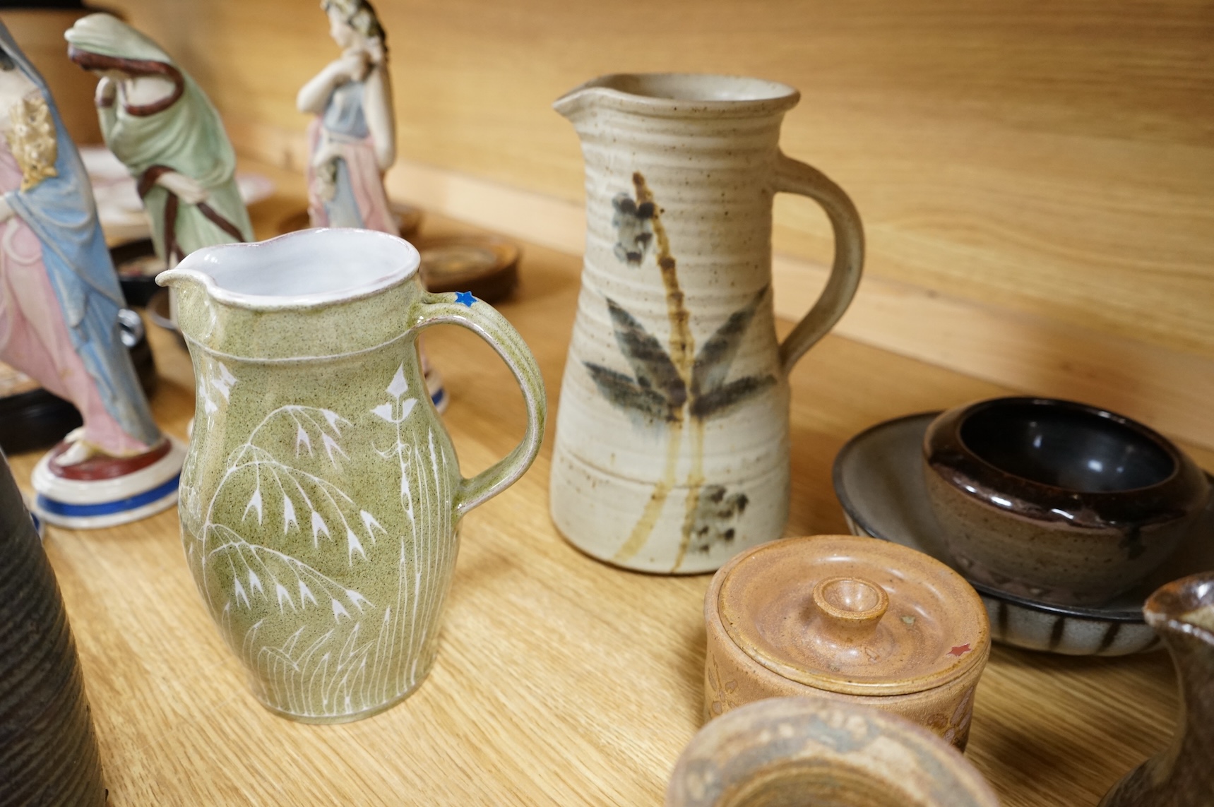 A large collection of studio pottery mugs bowls and jugs, tallest jug 21cm.